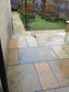 Tandur Yellow limestone paving slabs laid in a garden patio 